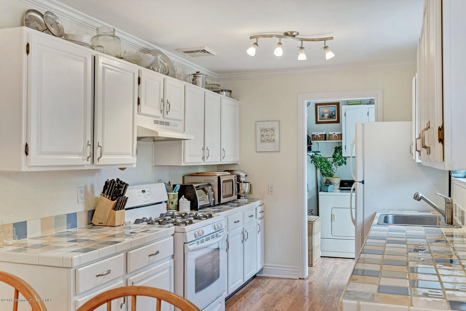 315 Stinson Road Brick, NJ 08723 - Photo 8 of 20 a kitchen with white cabinets and appliances