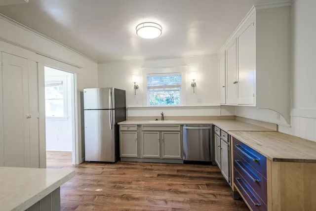 a kitchen with stainless steel appliances granite countertop a stove and a refrigerator