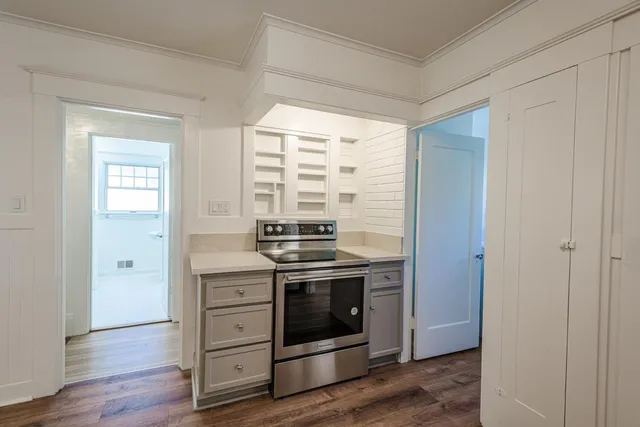 a kitchen with stainless steel appliances a stove a sink and cabinets
