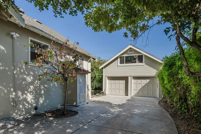a living room with furniture and a dining table with wooden floor