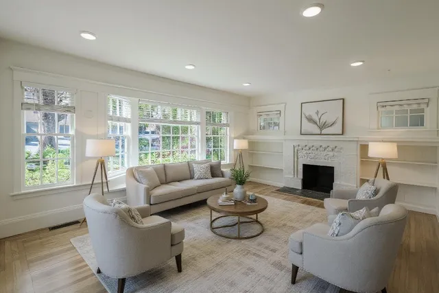 a living room with furniture and a fireplace