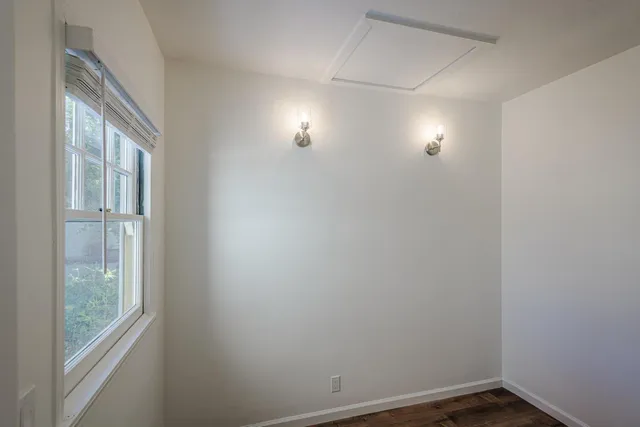 a view of small space with wooden floor and windows
