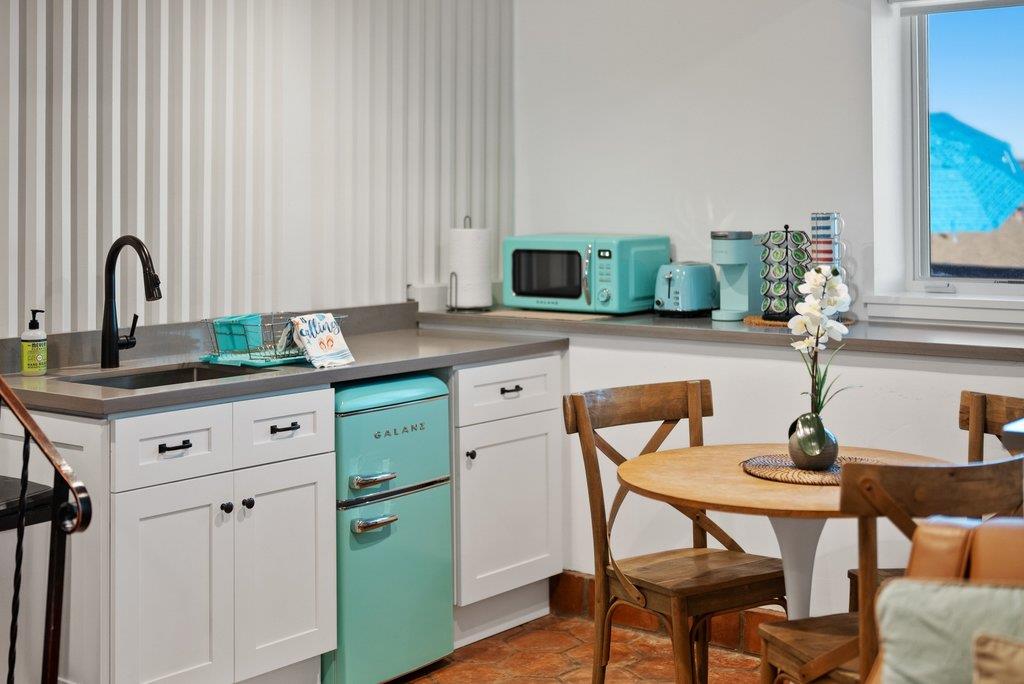 1500 Wharf Road, Unit 22 Capitola, CA 95010 - Photo 37 of 48 a view of a kitchen island with furniture and wooden floor