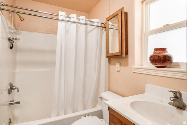 48 South Sage Road Pine Valley, UT 84781 - Photo 29 of 61 Bathroom featuring a white bathtub with chrome fixtures and shower curtain rod, a wood-finish medicine cabinet, and a white vanity with an integrated sink and chrome faucet