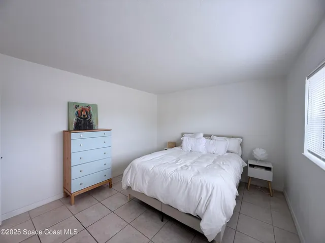 a bedroom with a bed and cabinets