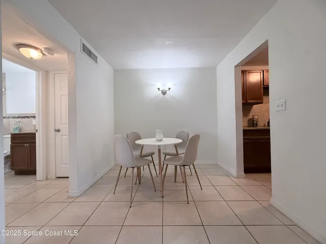 a view of a room with furniture and wooden floor