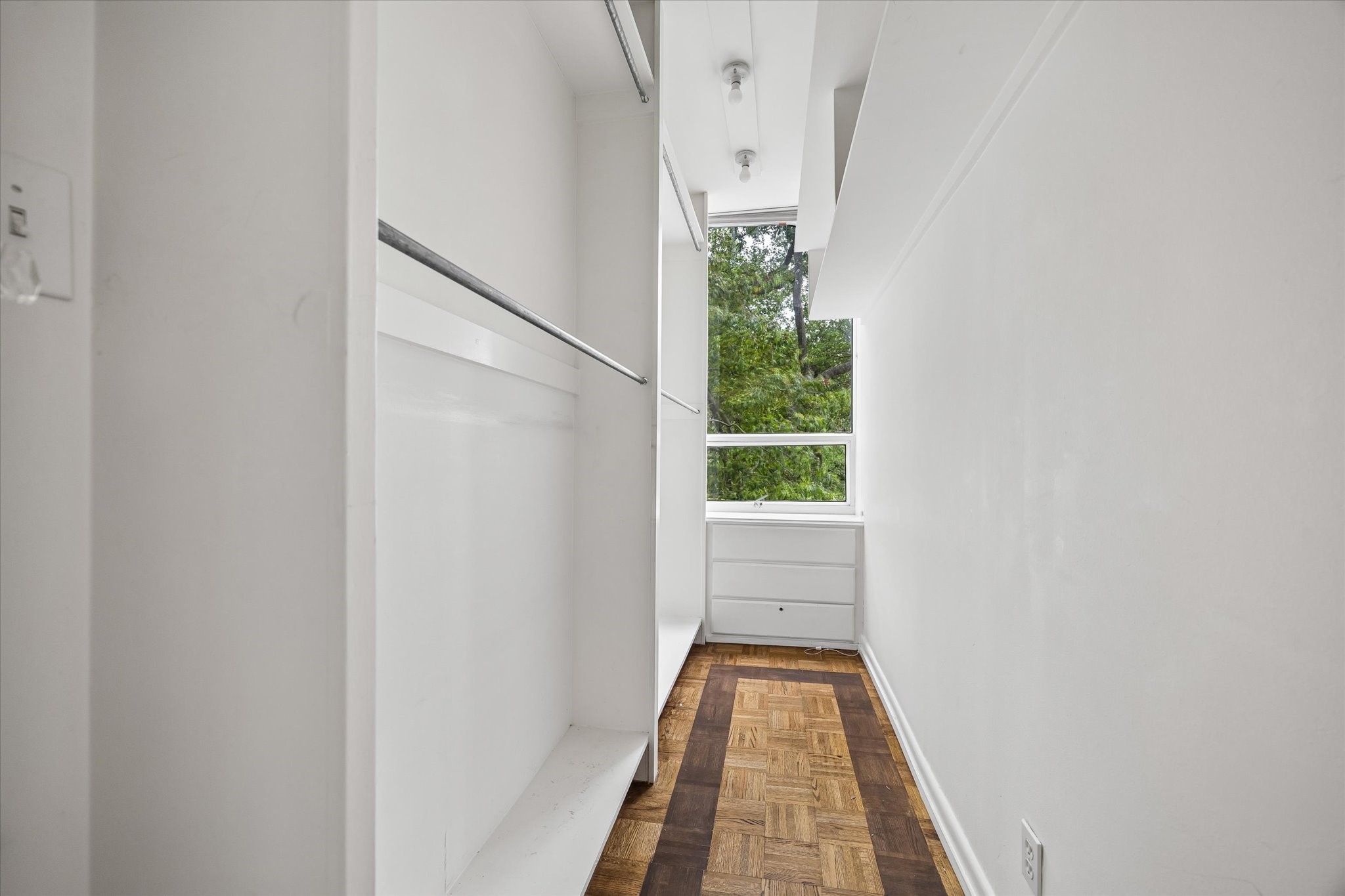 2701 Westheimer Road, Unit 2B Houston, TX 77098 - Photo 12 of 16 Primary bedroom walk-in closet with double hang and built-in drawers.