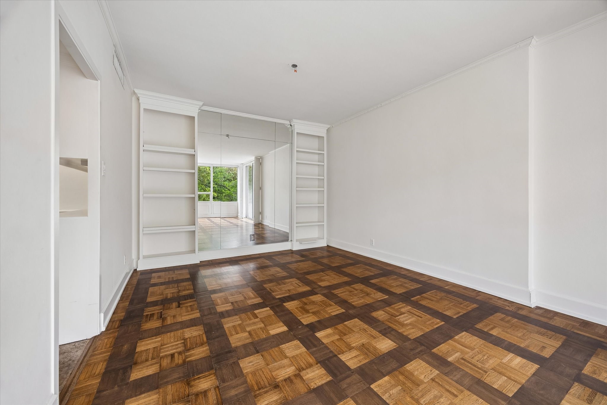 2701 Westheimer Road, Unit 2B Houston, TX 77098 - Photo 4 of 16 Dining room with built-in shelving and mirrored wall. Landlord will install a mutually agreed upon dining room light fixture.