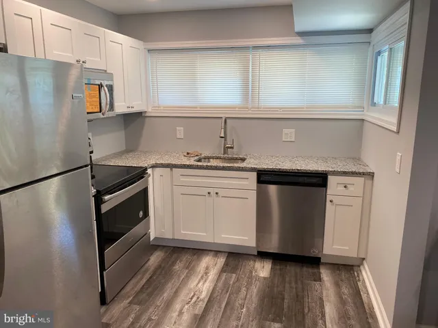 a kitchen with a sink stove and refrigerator