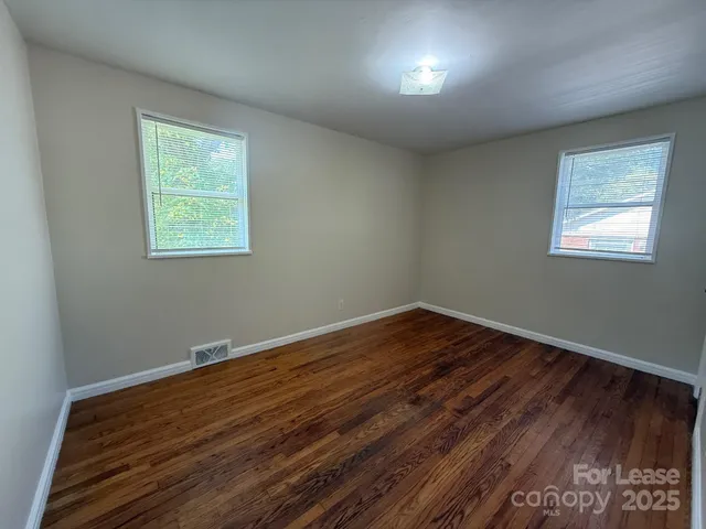 a view of room with hardwood floor and window