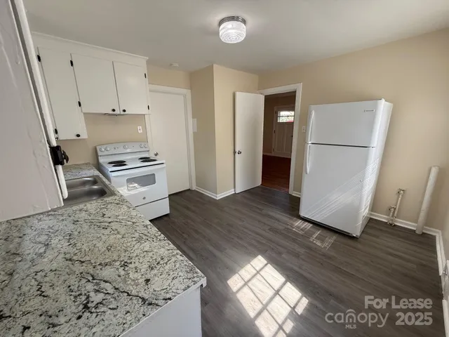 a kitchen with a refrigerator and a stove