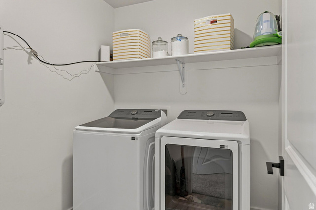 355 West 3085 South Logan, UT 84321 - Photo 35 of 40 White laundry appliances with a top-load washer and front-load dryer
