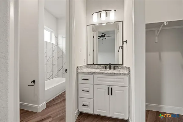 a bathroom with a double vanity sink and mirror with shower