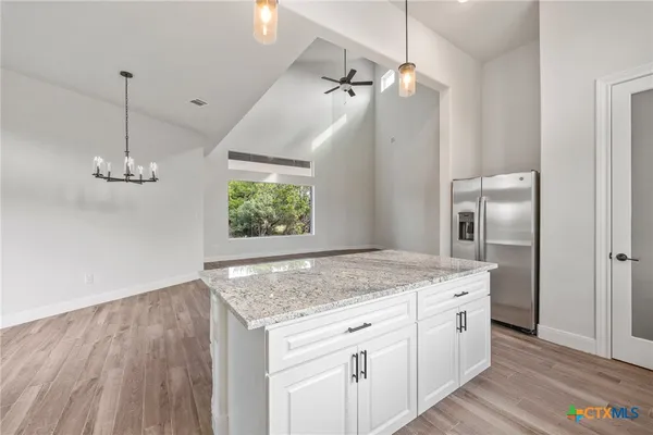 a kitchen with a sink a counter space and wooden floor