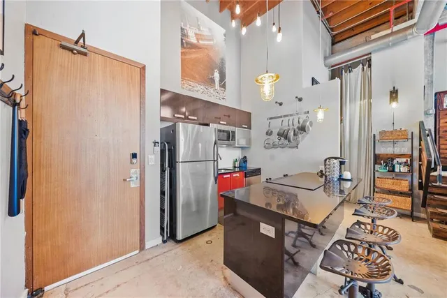 a kitchen view of a table and chairs in it