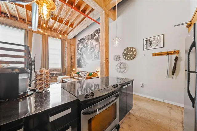 a kitchen with stainless steel appliances granite countertop a lot of counter space and a window
