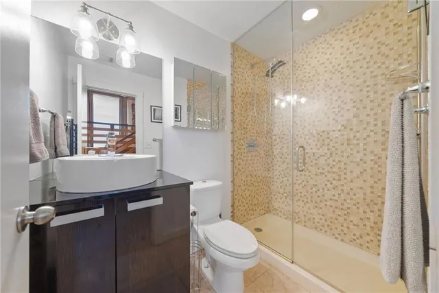 a bathroom with a sink toilet and shower