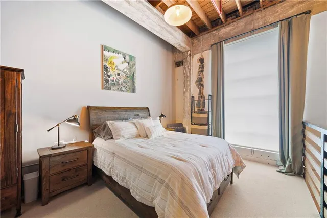 a bedroom with bed and a window