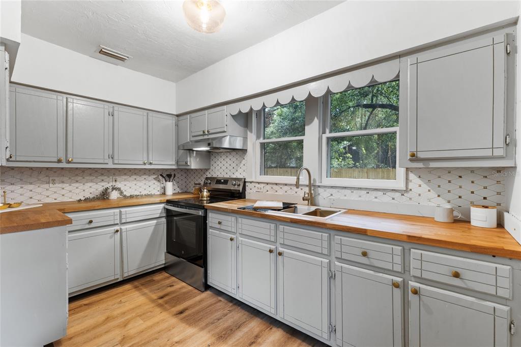 902 Northwest 4th Place Gainesville, FL 32601 - Photo 16 of 33 a kitchen with a sink and cabinets