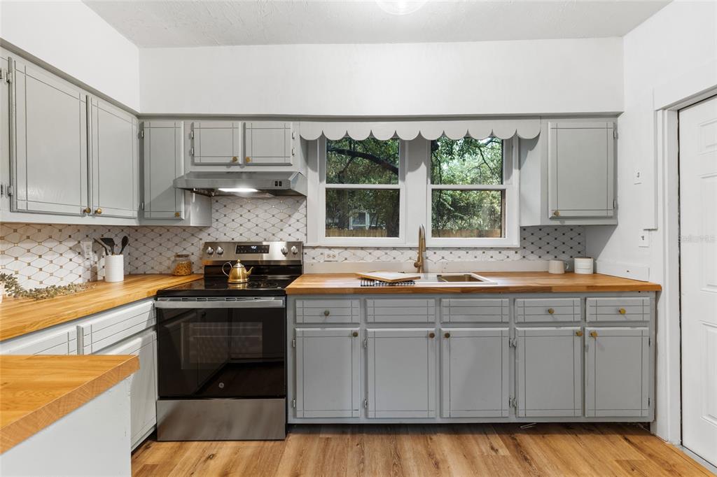 902 Northwest 4th Place Gainesville, FL 32601 - Photo 17 of 33 a kitchen with a sink and cabinets