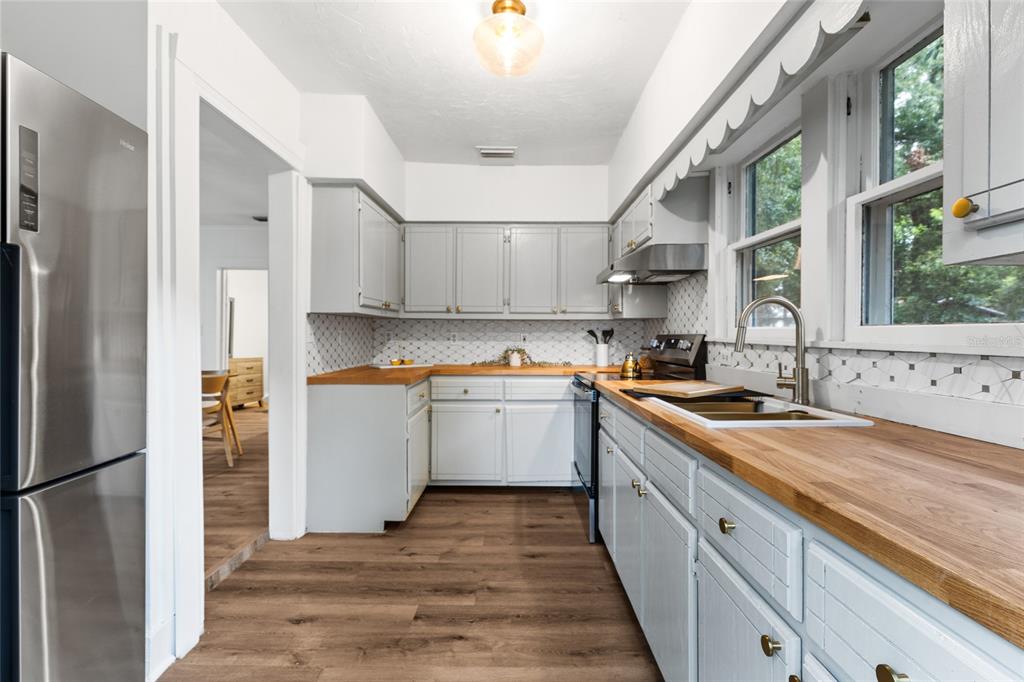902 Northwest 4th Place Gainesville, FL 32601 - Photo 18 of 33 a kitchen with a sink stove and refrigerator