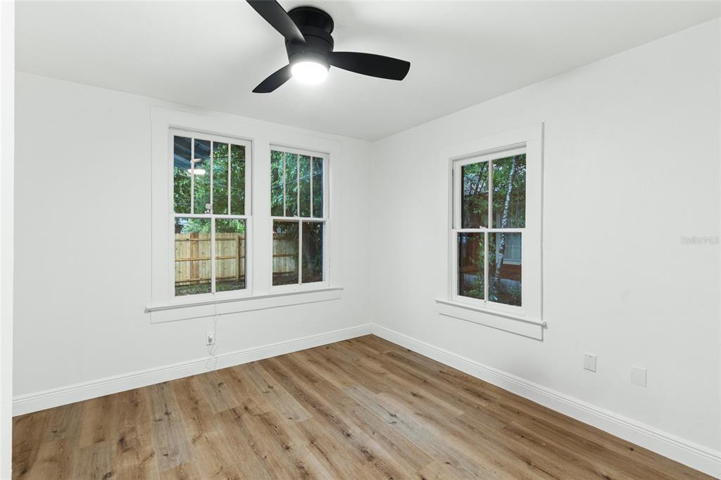902 Northwest 4th Place Gainesville, FL 32601 - Photo 20 of 33 an empty room with wooden floor cabinet and windows