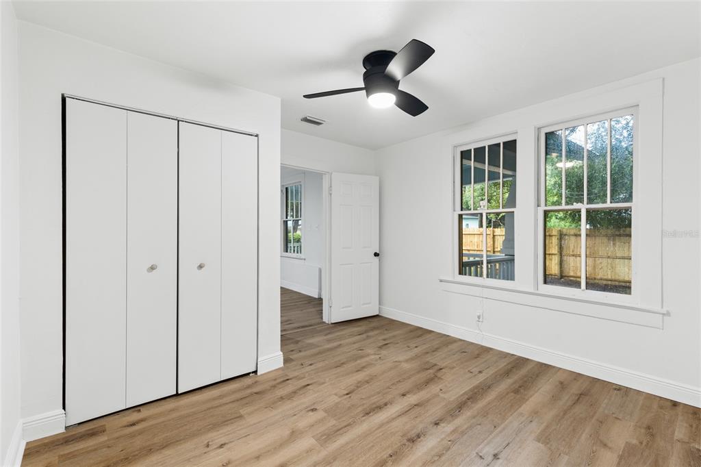 902 Northwest 4th Place Gainesville, FL 32601 - Photo 21 of 33 a view of an empty room with a window and wooden floor