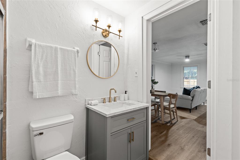 902 Northwest 4th Place Gainesville, FL 32601 - Photo 24 of 33 a en suite bathroom with a double vanity sink and a mirror