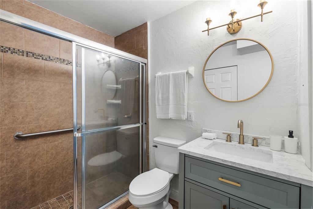 902 Northwest 4th Place Gainesville, FL 32601 - Photo 25 of 33 a bathroom with a granite countertop sink mirror vanity and toilet