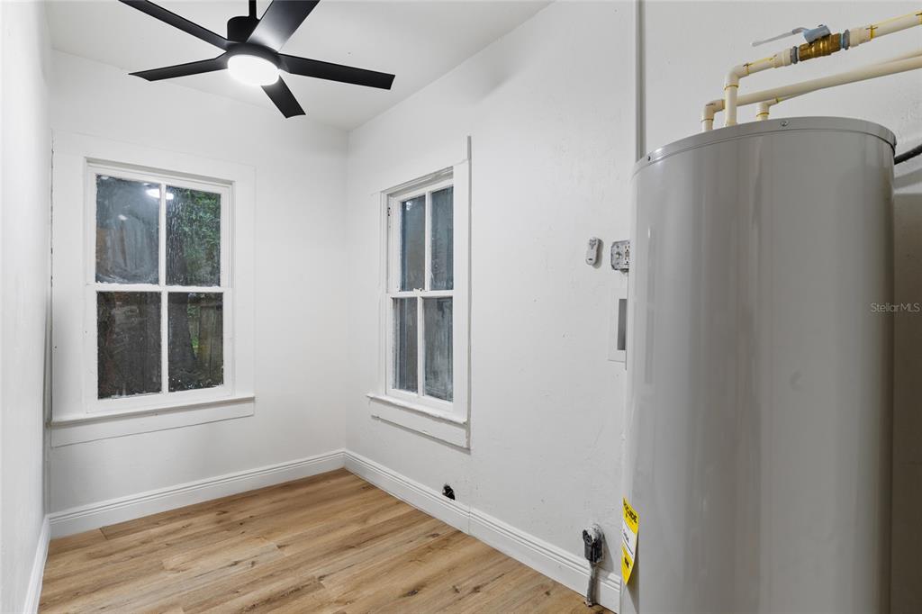 902 Northwest 4th Place Gainesville, FL 32601 - Photo 26 of 33 a view of an empty room with a window and wooden floor