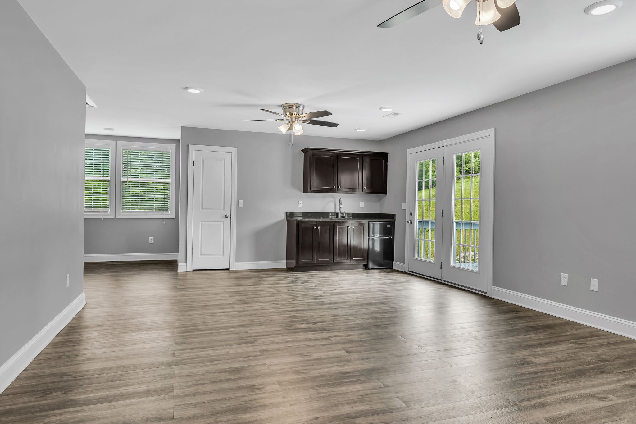 150 Hickman Highway Hickman, TN 38567 - Photo 22 of 42 an empty room with wooden floor cabinet and a fireplace