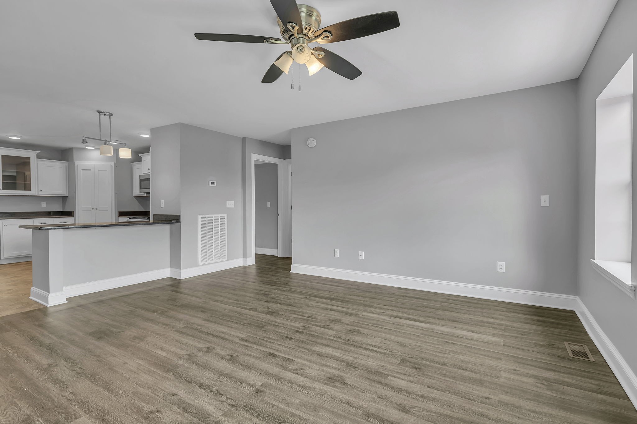 150 Hickman Highway Hickman, TN 38567 - Photo 4 of 42 a view of an empty room and kitchen with wooden floor