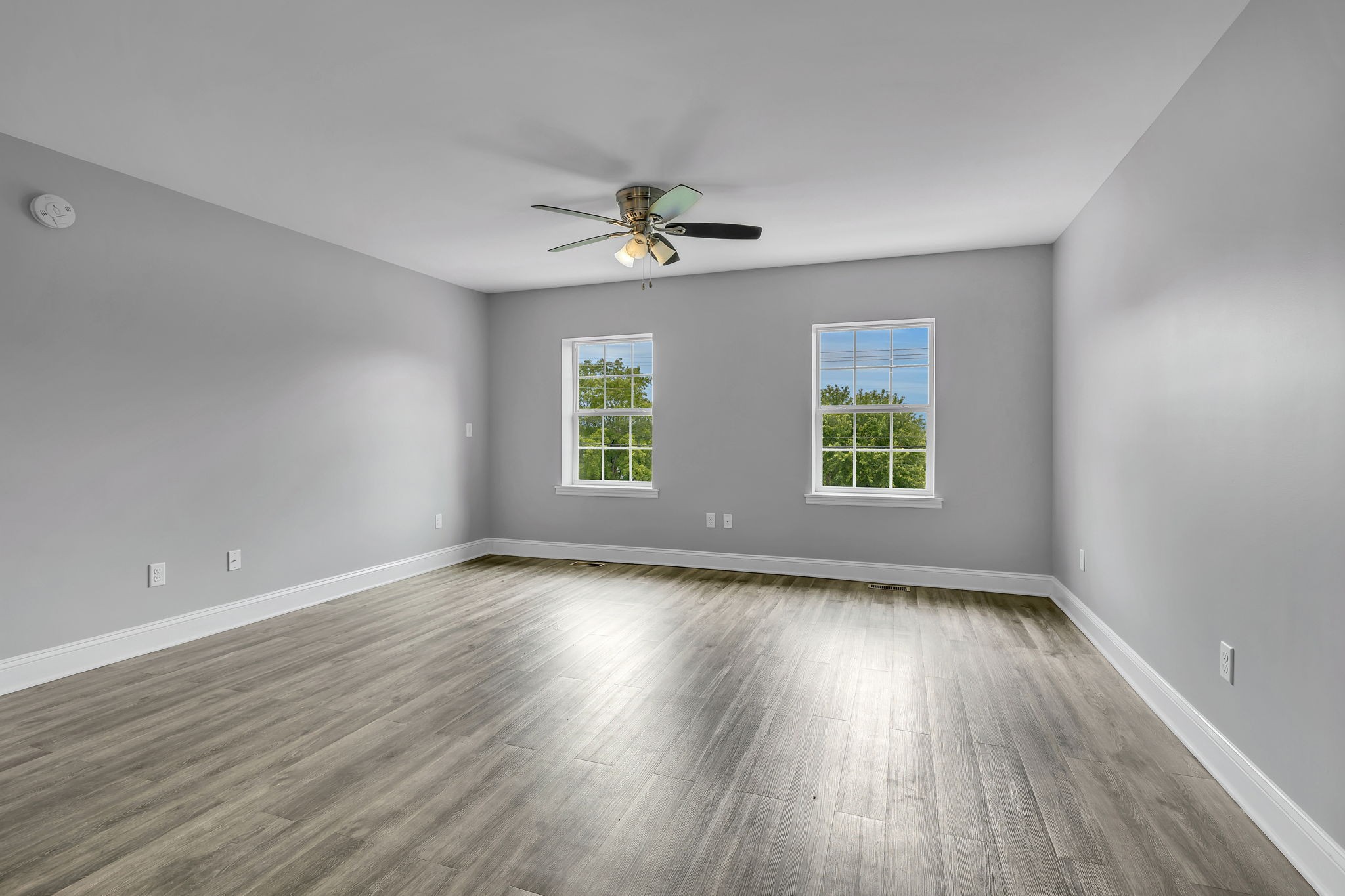 150 Hickman Highway Hickman, TN 38567 - Photo 5 of 42 an empty room with wooden floor ceiling fan and windows