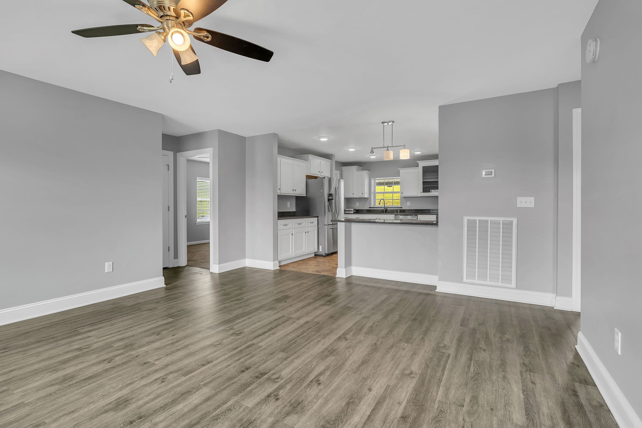 150 Hickman Highway Hickman, TN 38567 - Photo 6 of 42 a view of a kitchen with a fridge and wooden floor