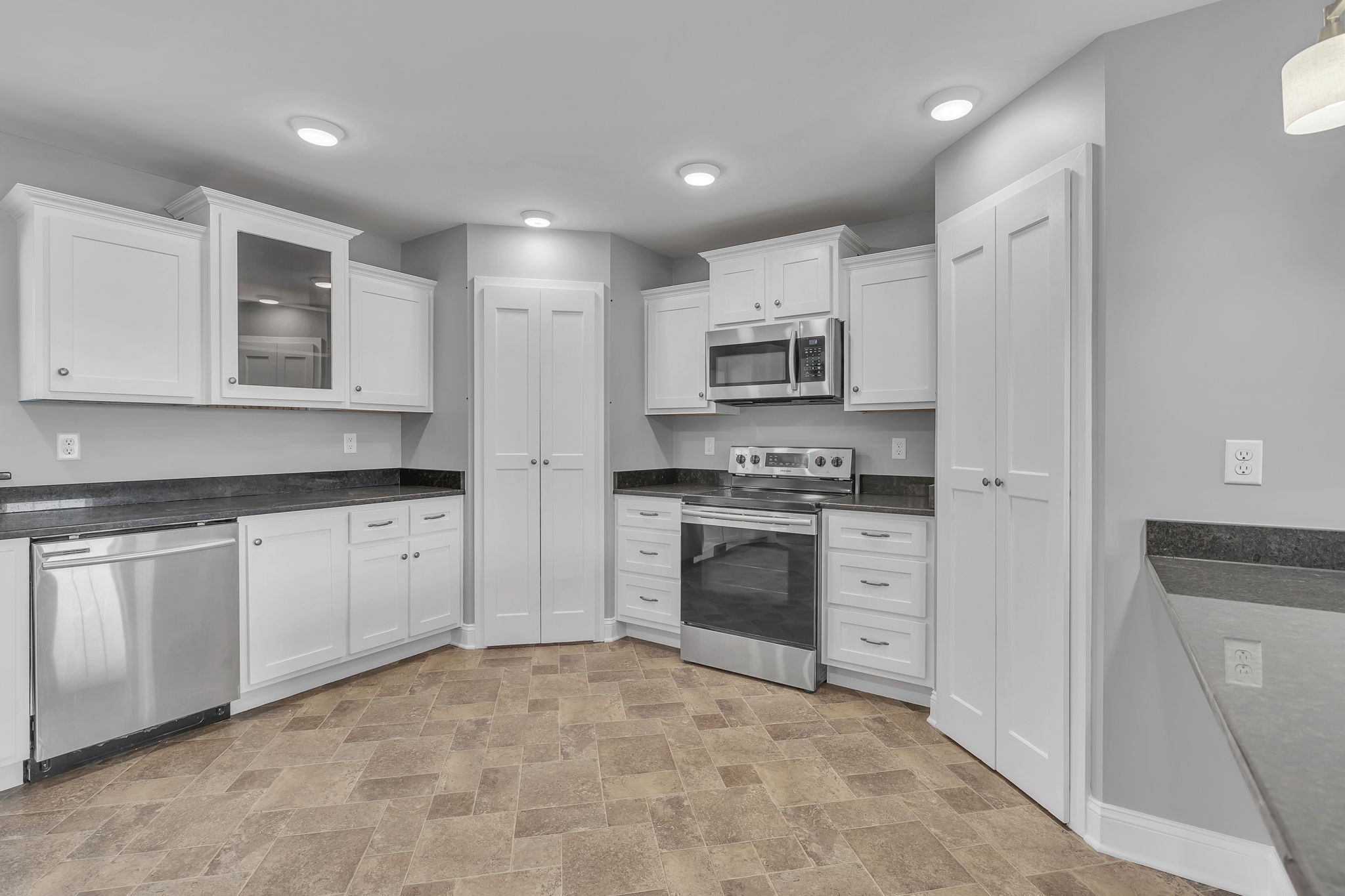 150 Hickman Highway Hickman, TN 38567 - Photo 8 of 42 a kitchen with kitchen island granite countertop white cabinets and stainless steel appliances