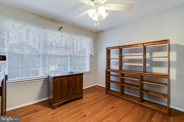 a view of room with wooden floor and window