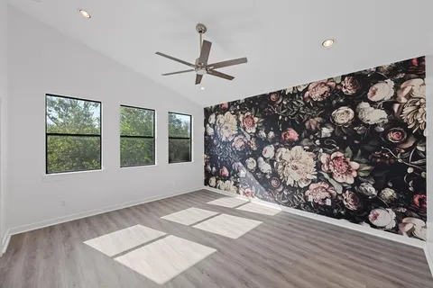 a view of wooden floor and windows in a room