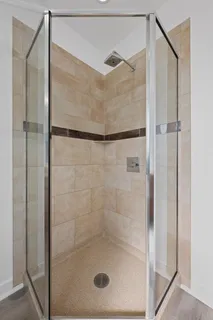 a bathroom with a glass shower door