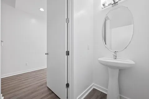 a room with a mirror and a wooden floor