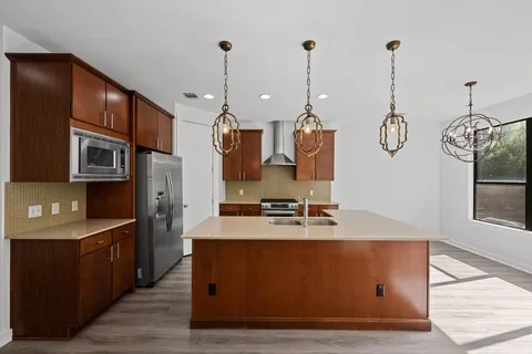 a very nice looking room with kitchen island furniture and a chandelier