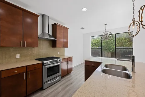 a kitchen that has a sink and a stove