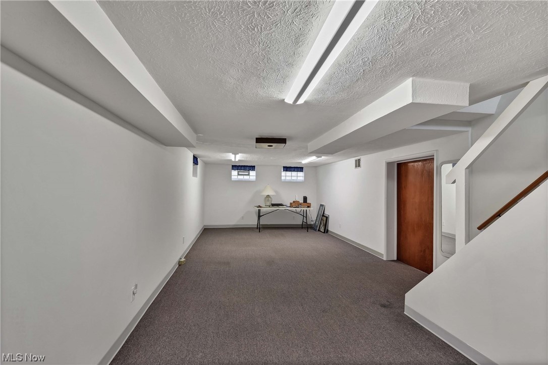 5740 Hauserman Road Parma, OH 44130 - Photo 32 of 35 Basement featuring dark carpet and a textured ceiling
