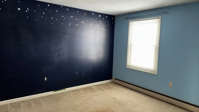 a view of an empty room and a window