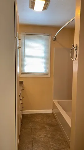 a bathroom with a glass shower door