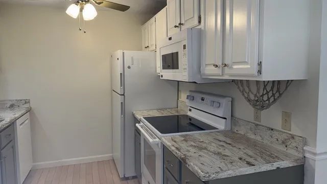 a kitchen with stainless steel appliances granite countertop a sink a stove and a refrigerator