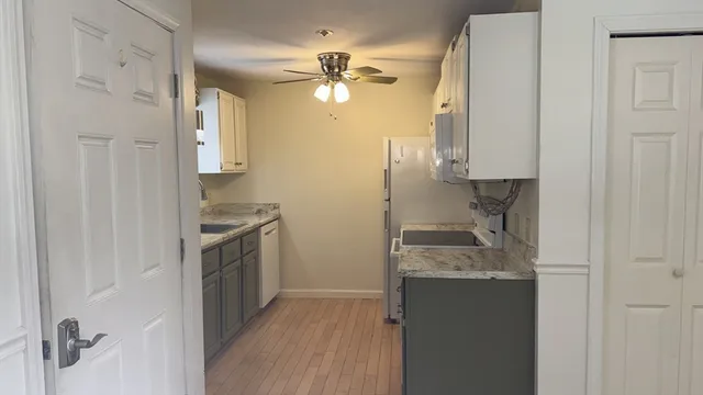 a kitchen with a refrigerator and a sink