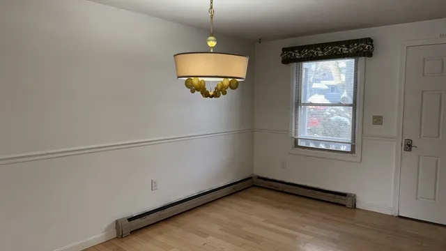 a view of a room with wooden floor and windows