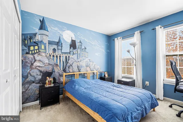 a bedroom with a bed and windows