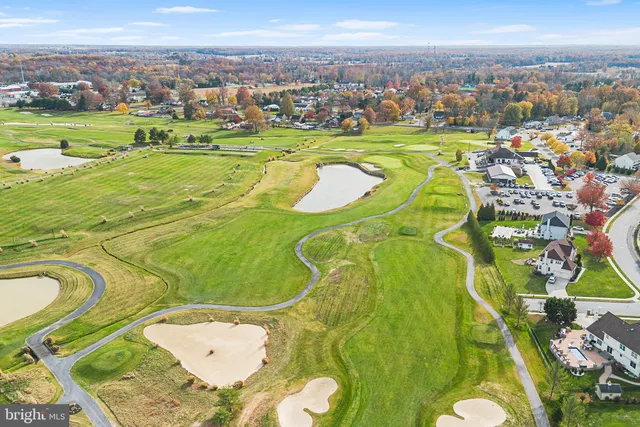 an aerial view of a swimming pool with a yard