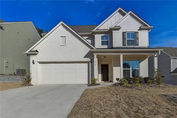 a view of a house with a yard and garage